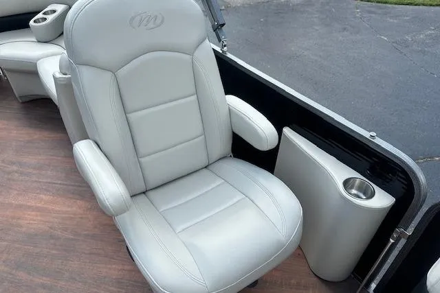 Slide: The Image of Luxurious seating on 2017 Manitou 23 Oasis boat with cup holder and armrests. - 26