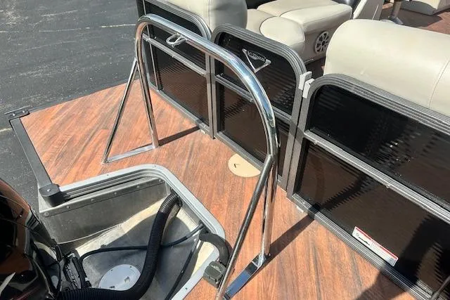 Slide: The Image of 2017 Manitou 23 Oasis boat interior with seating and railing. - 8