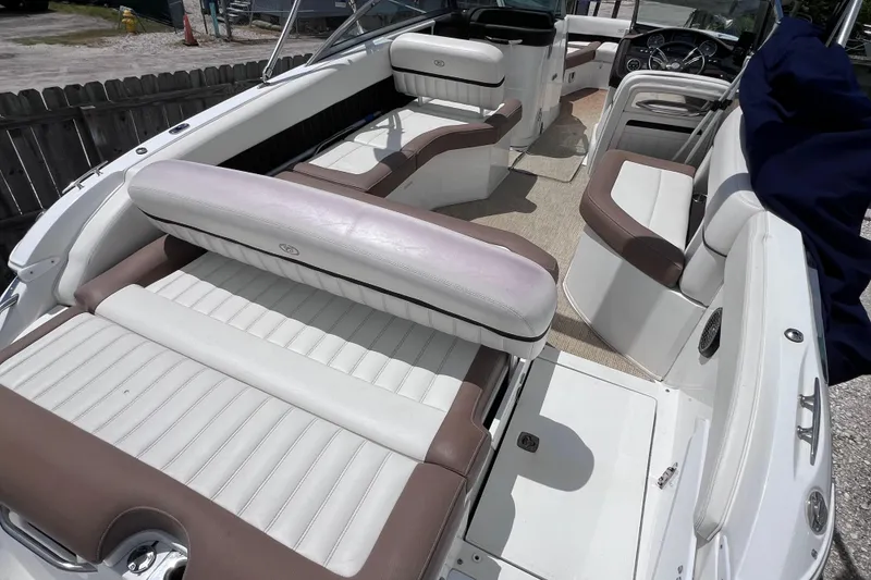 Slide: The Image of 2015 Cobalt 26SD boat interior with white and brown seating, steering wheel visible. - 13