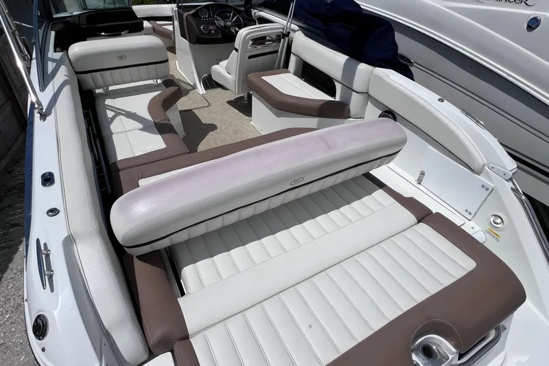 Slide: The Image of 2015 Cobalt 26SD boat interior with white and brown seating, spacious layout. - 14