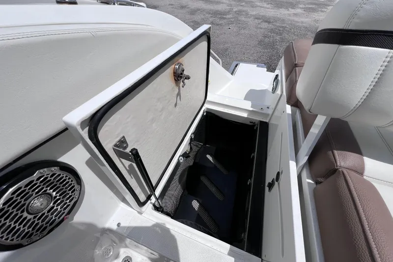 Slide: The Image of 2015 Cobalt 26SD boat storage compartment with open hatch and speaker detail. - 19