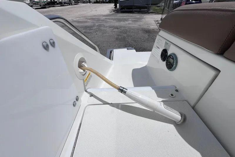 Slide: The Image of 2015 Cobalt 26SD boat deck with hose connection and control panel. - 20