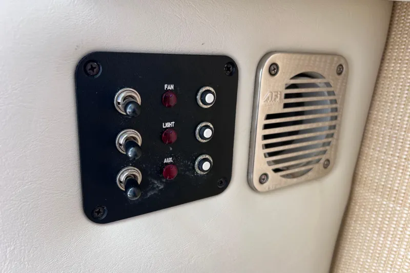 Slide: The Image of Control panel and speaker on a 2015 Cobalt 26SD boat interior. - 27