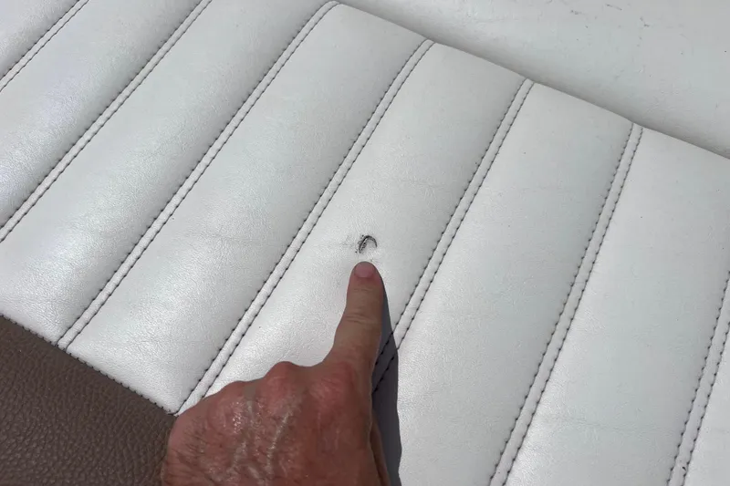 Slide: The Image of Close-up of a 2015 Cobalt 26SD boat seat with a small tear. - 29