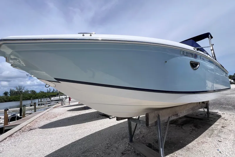 Slide: The Image of 2015 Cobalt 26SD boat on dry dock, side view under clear sky. - 3