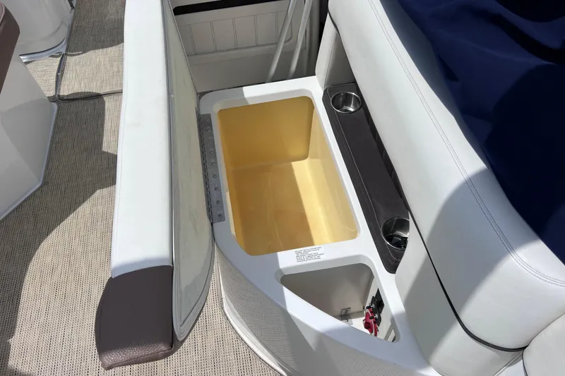 Slide: The Image of 2015 Cobalt 26SD boat interior with open storage compartment and cup holders. - 30