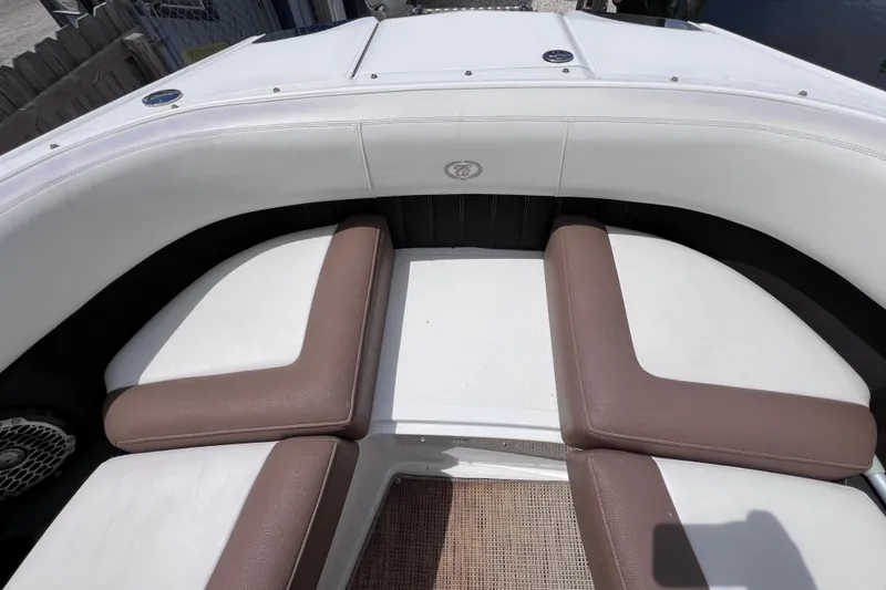 Slide: The Image of 2015 Cobalt 26SD boat interior with white and brown cushioned seating. - 34