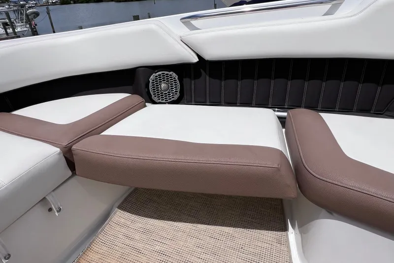 Slide: The Image of 2015 Cobalt 26SD boat interior with brown and white seating, speaker, and carpeted floor. - 37