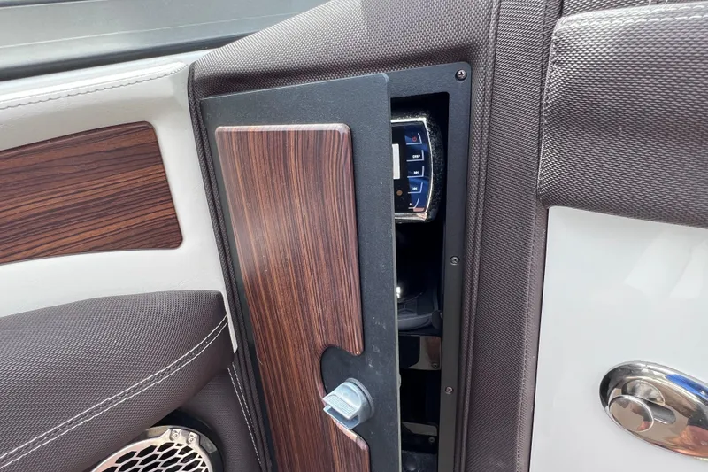 Slide: The Image of Interior detail of a 2015 Cobalt 26SD boat, featuring wood paneling and speaker. - 39