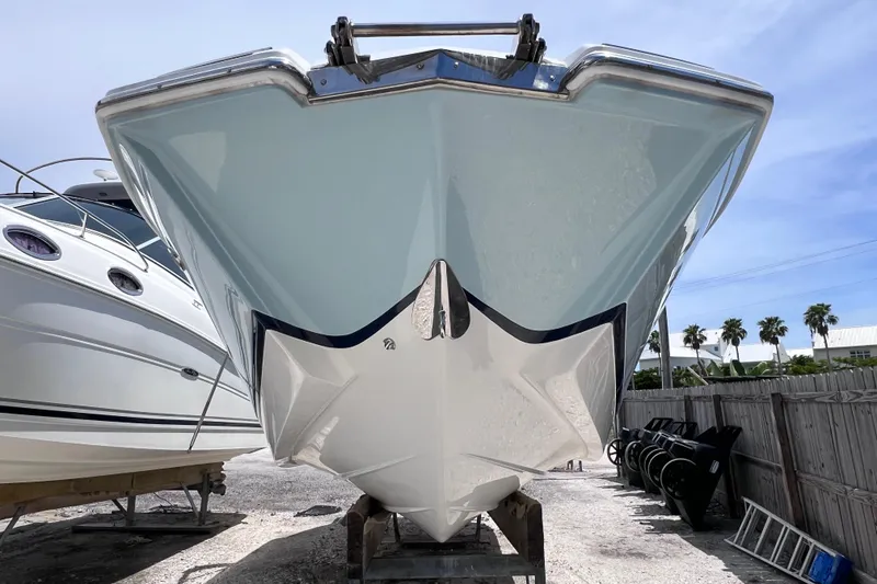 Slide: The Image of 2015 Cobalt 26SD boat front view, parked outdoors on a sunny day. - 4
