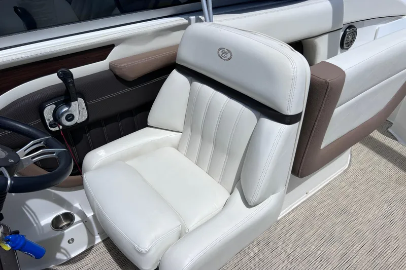 Slide: The Image of 2015 Cobalt 26SD boat interior with white leather seating and steering wheel. - 41