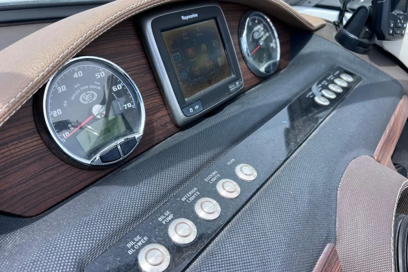 Slide: The Image of Dashboard of a 2015 Cobalt 26SD boat with gauges and controls. - 44