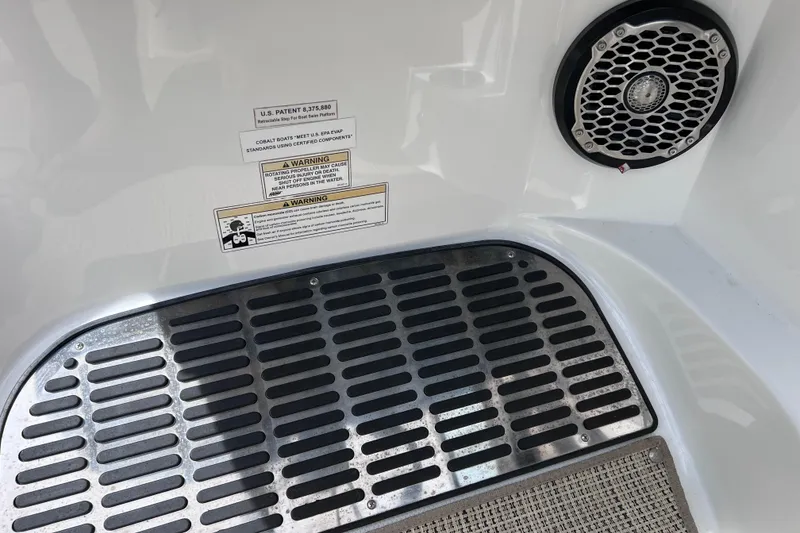 Slide: The Image of 2015 Cobalt 26SD boat interior with speaker and safety warning labels. - 49