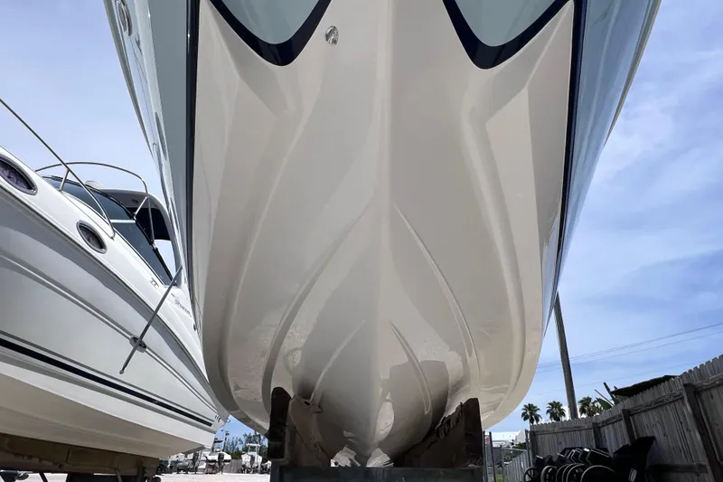 Slide: The Image of 2015 Cobalt 26SD boat hull in dry dock, showcasing sleek design and craftsmanship. - 5