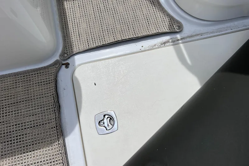 Slide: The Image of 2015 Cobalt 26SD boat deck with textured flooring and metal latch. - 50