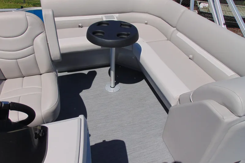 Slide: The Image of Interior of 2026 Godfrey eX1680 CX pontoon boat with beige seating and cupholder table. - 8