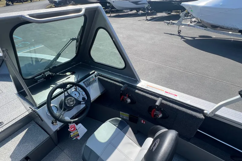 Slide: The Image of Interior view of 2025 Crestliner 1850 Commander boat, showcasing steering wheel and controls. - 11
