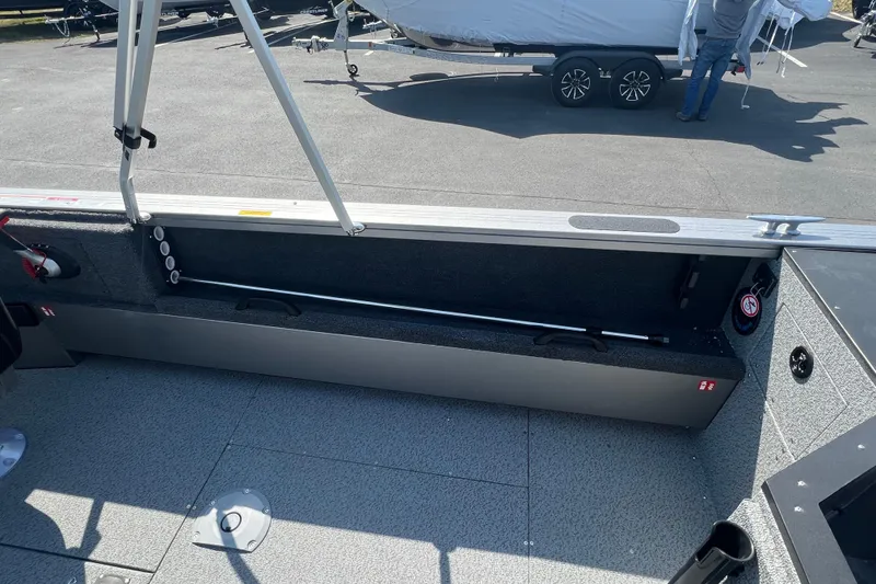 Slide: The Image of 2025 Crestliner 1850 Commander boat interior with storage compartment open. - 14