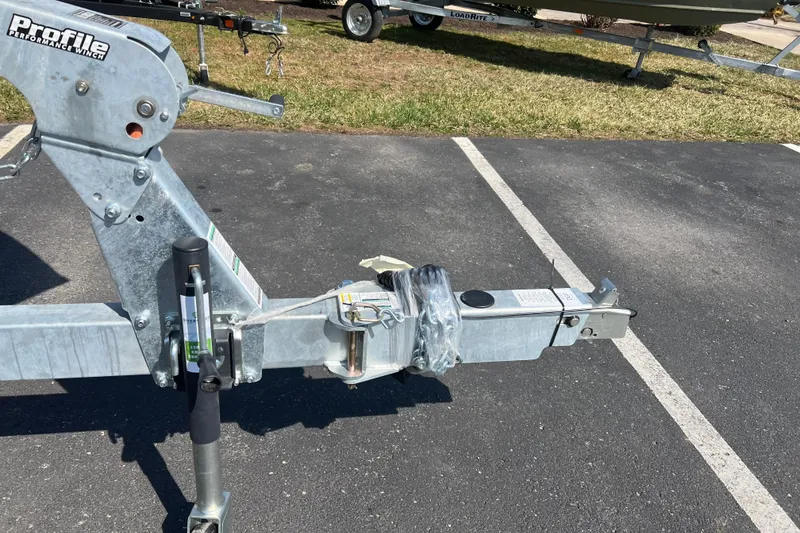 Slide: The Image of Trailer hitch of a 2025 Crestliner 1850 Commander boat in a parking lot. - 2