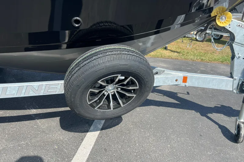 Slide: The Image of Trailer wheel of 2025 Crestliner 1850 Commander boat on pavement. - 3