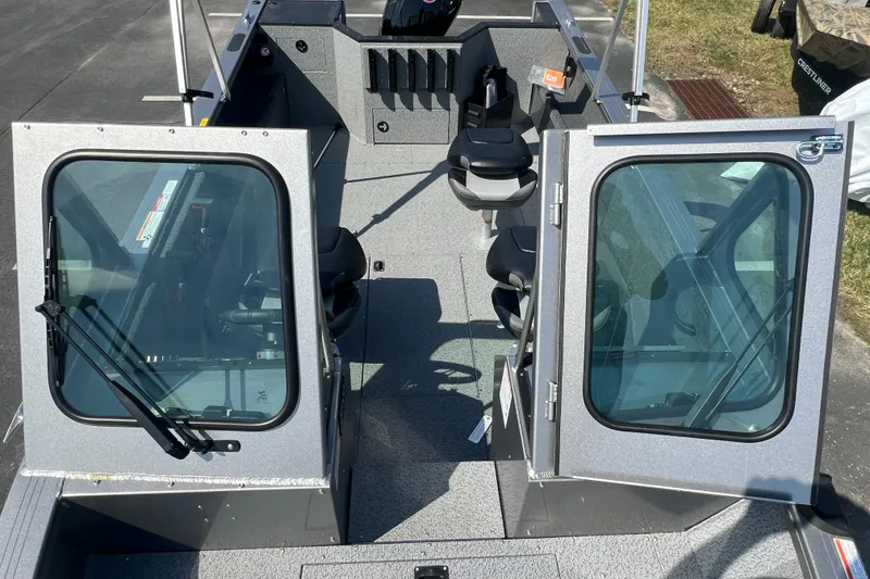 Slide: The Image of 2025 Crestliner 1850 Commander boat interior with open doors and seating arrangement. - 7