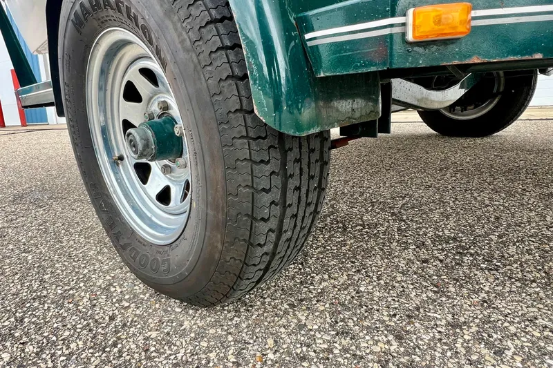Slide: The Image of Trailer tire of a 2000 Four Winns 190 Horizon SS on asphalt. - 4