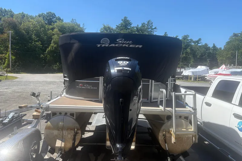 Slide: The Image of 2021 Sun Tracker Party Barge 20 DLX pontoon boat with Mercury engine, parked outdoors. - 2