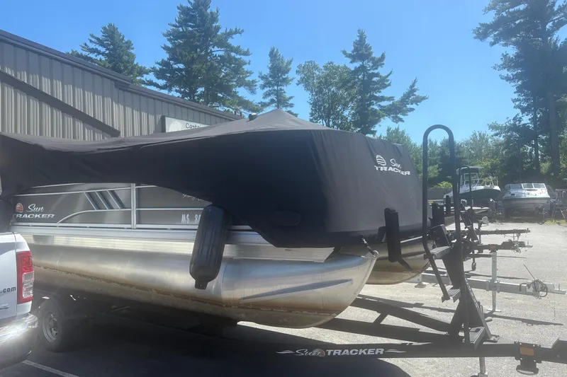 Slide: The Image of 2021 Sun Tracker Party Barge 20 DLX pontoon boat on trailer, covered, outdoors. - 3