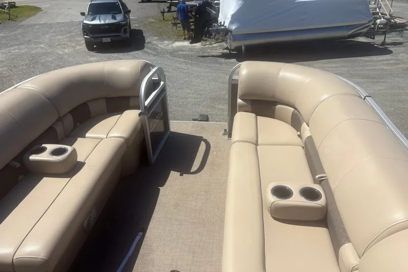 Slide: The Image of 2021 Sun Tracker Party Barge 20 DLX with beige seating and cup holders. - 5