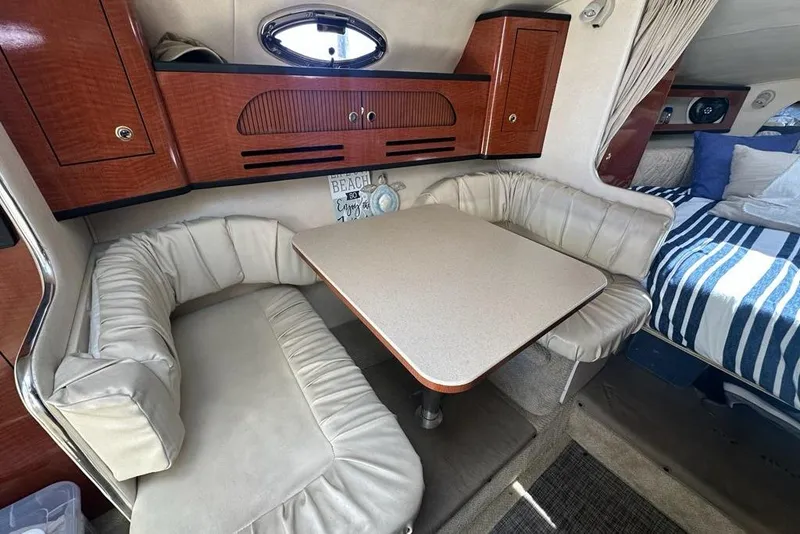 Slide: The Image of Interior of 2004 Sea Ray 280 Sundancer with cozy seating and dining area. - 16