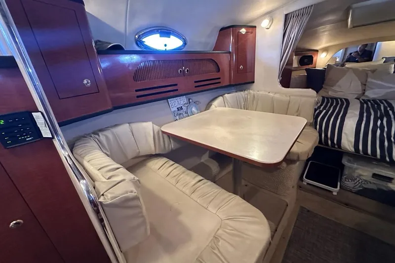 Slide: The Image of Interior of 2004 Sea Ray 280 Sundancer with cozy seating and dining area. - 18