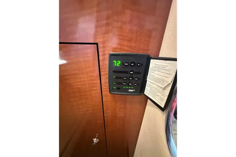 Slide: The Image of Thermostat control panel on 2004 Sea Ray 280 Sundancer boat interior. - 24