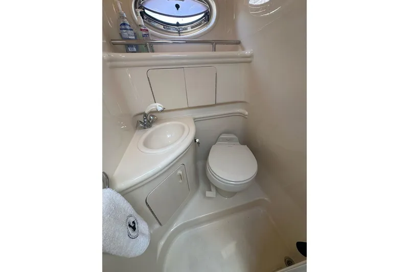Slide: The Image of Compact bathroom in 2004 Sea Ray 280 Sundancer boat, featuring sink and toilet. - 25