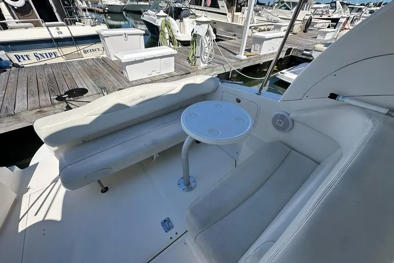Slide: The Image of 2004 Sea Ray 280 Sundancer boat interior with seating and table at marina. - 29