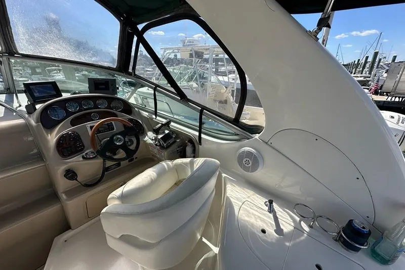Slide: The Image of 2004 Sea Ray 280 Sundancer helm with steering wheel, gauges, and navigation equipment. - 3