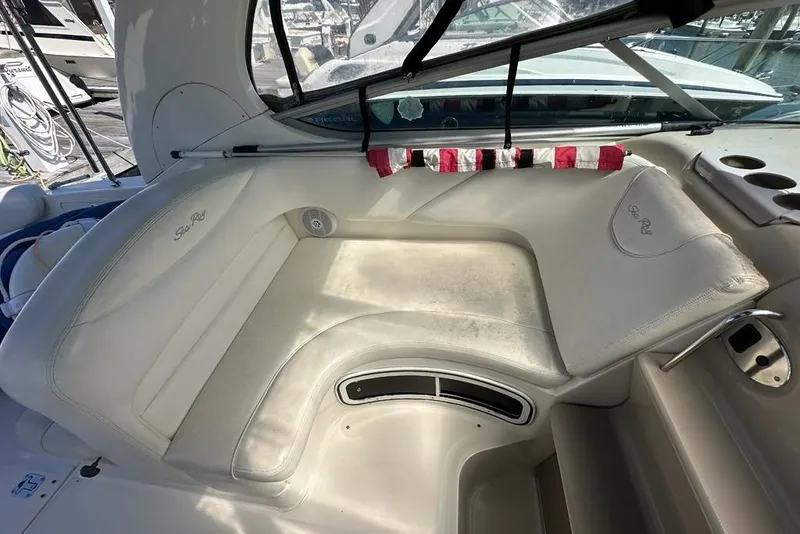 Slide: The Image of 2004 Sea Ray 280 Sundancer interior with white leather seating and cup holders. - 5