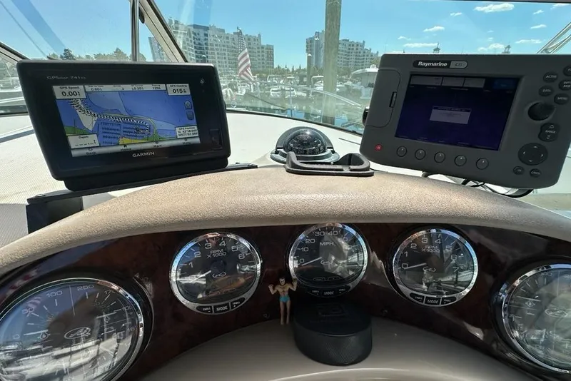Slide: The Image of Dashboard of a 2004 Sea Ray 280 Sundancer with Garmin and Raymarine navigation systems. - 8