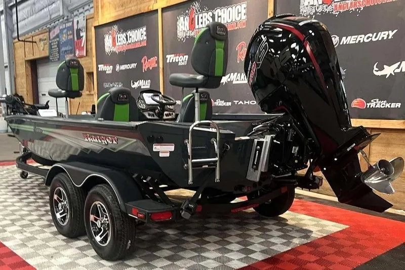 Slide: The Image of 2026 Ranger RT188P boat with dual seats and powerful outboard motor on display. - 3