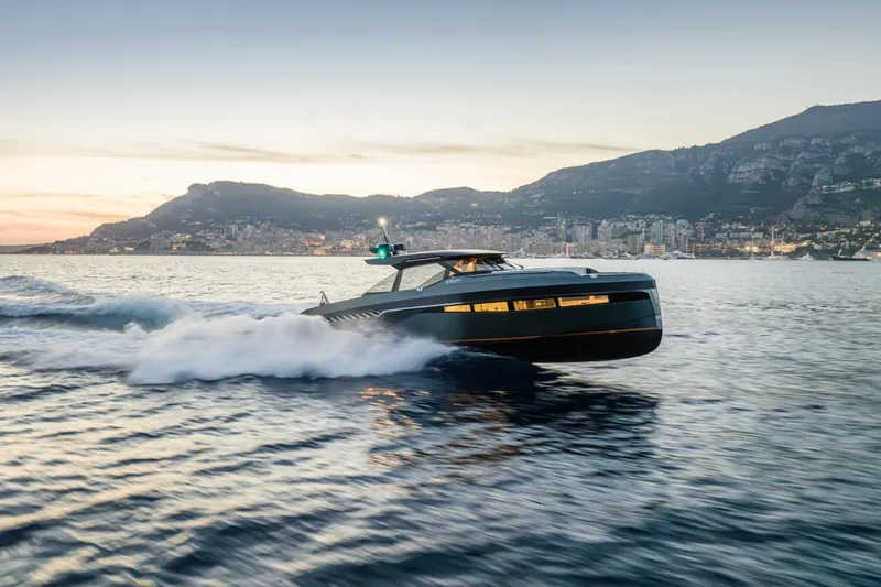 The Image of Bekkers Yachts Azur 45HT 2023 cruising on water at sunset near coastal city. - 0