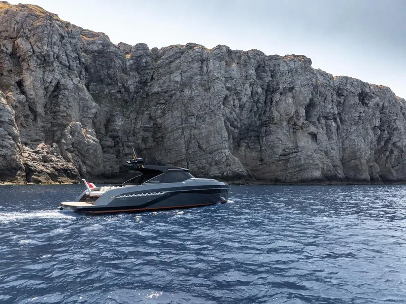 Slide: The Image of 2023 Bekkers Yachts Azur 45HT cruising near rocky cliffs on a sunny day. - 45