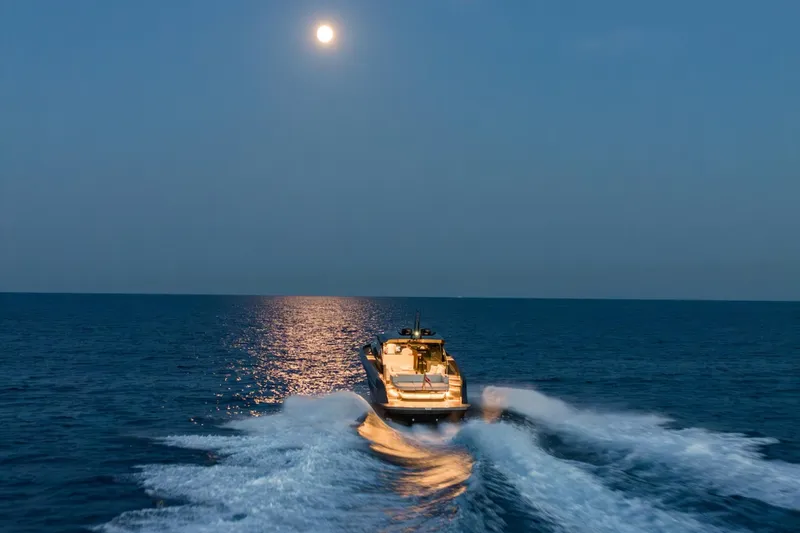 Slide: The Image of Bekkers Yachts Azur 45HT cruising under moonlight, 2023 model, creating waves on open sea. - 4