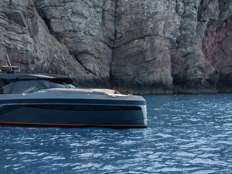 Slide: The Image of 2023 Bekkers Yachts Azur 45HT cruising near rocky cliffs in serene blue waters. - 46