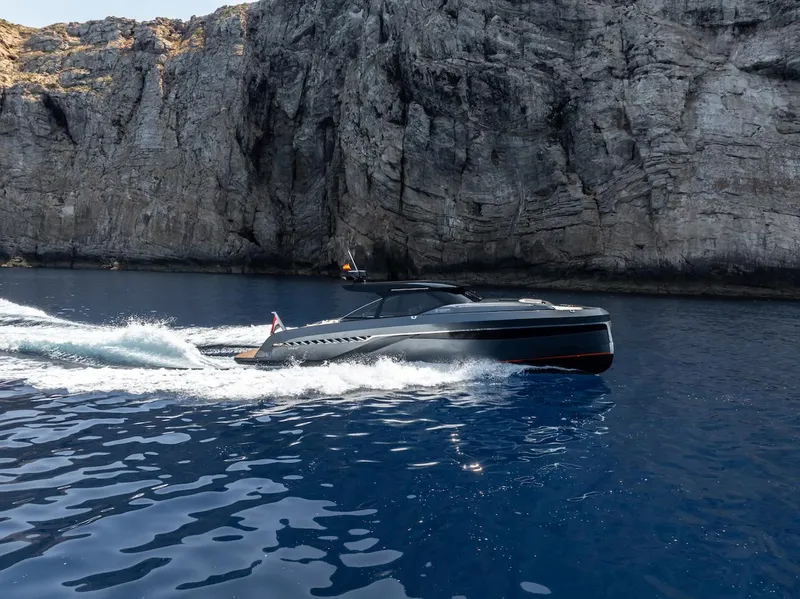 Slide: The Image of 2023 Bekkers Yachts Azur 45HT cruising near rocky cliffs on a clear blue sea. - 48