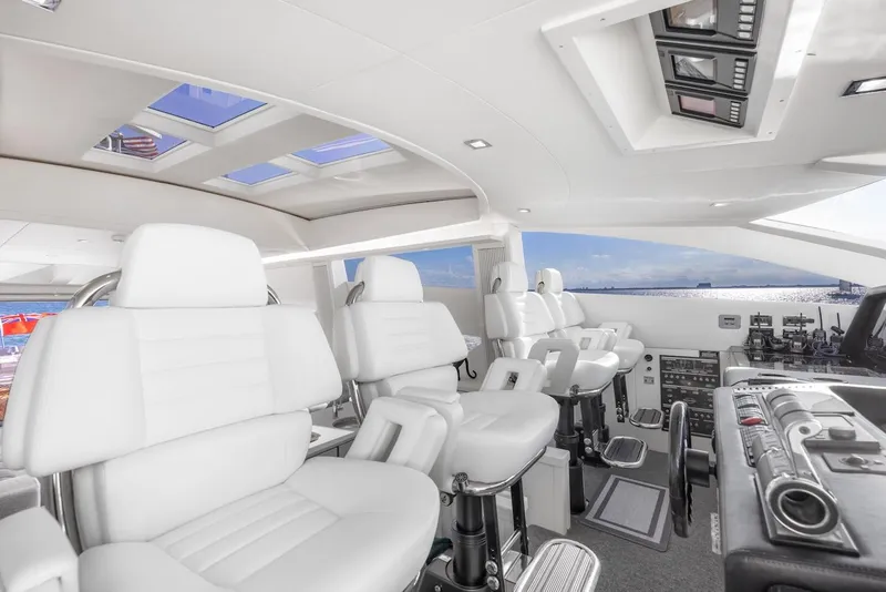 Slide: The Image of Interior of 2008 Sunseeker Predator 108 yacht with modern white seating and control panels. - 13