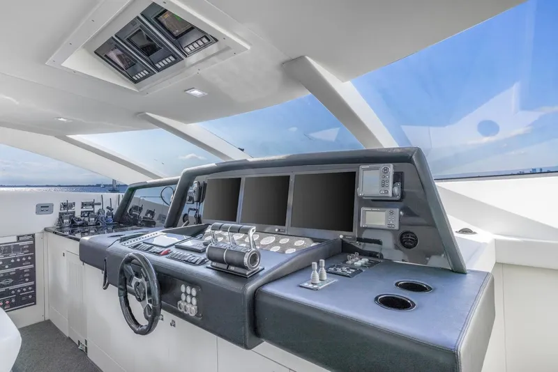 Slide: The Image of Helm of 2008 Sunseeker Predator 108 yacht with modern navigation equipment and sleek design. - 14
