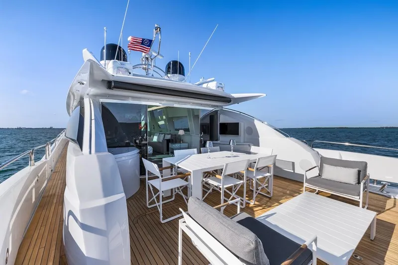 Slide: The Image of Luxurious 2008 Sunseeker Predator 108 yacht deck with seating and dining area on open water. - 18