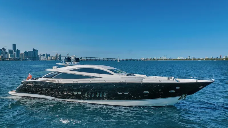 Slide: The Image of 2008 Sunseeker Predator 108 yacht cruising on blue waters near a city skyline. - 4