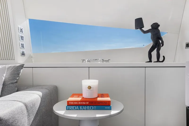 Slide: The Image of Luxurious Sunseeker Predator 108 interior with books, candle, and monkey sculpture. - 9