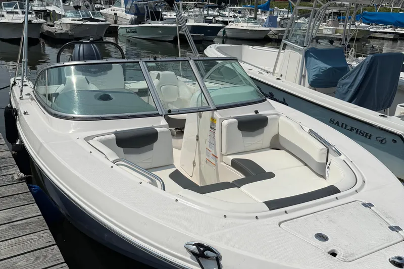 Slide: The Image of 2023 Robalo R207 Dual Console boat docked at marina, featuring spacious seating. - 3