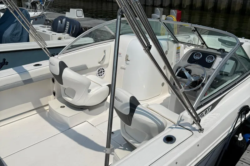Slide: The Image of 2023 Robalo R207 Dual Console boat interior with seating and steering wheel. - 4